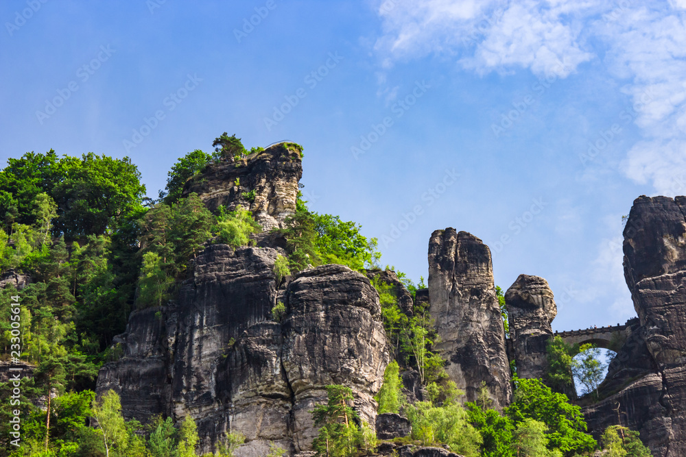 View up on stone formations and the famous Bastei bridge in Saxony, Germany