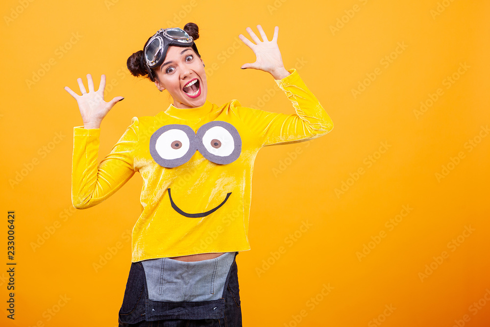 Beautiful young woman wearing funny minion pullover. Funny moment