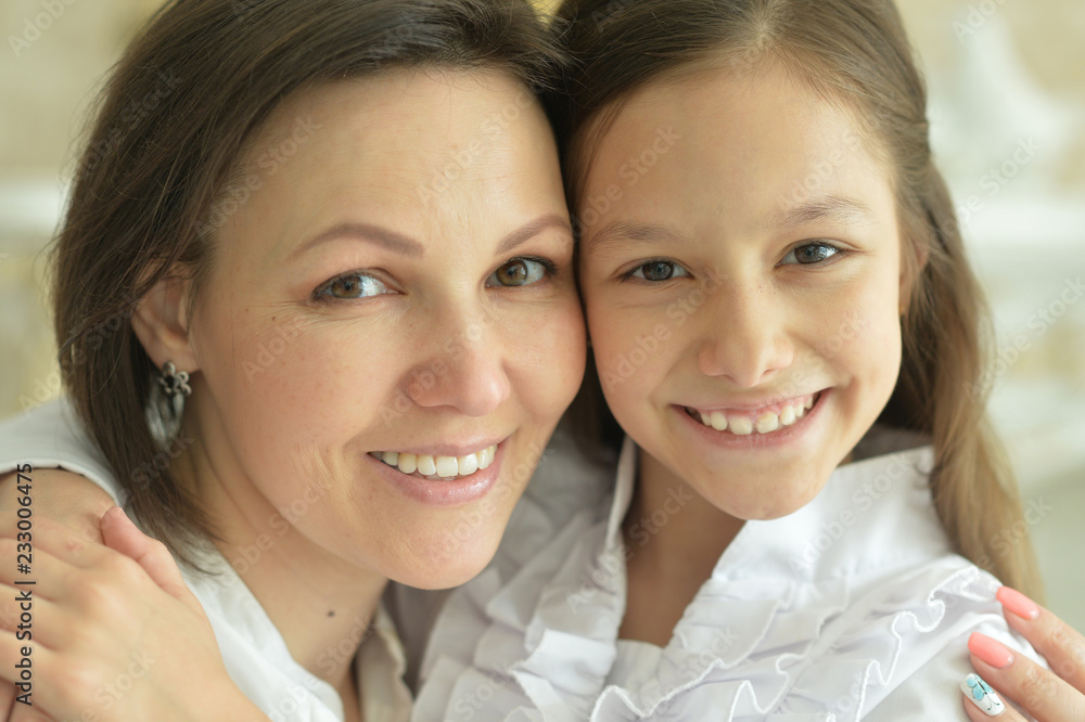 Portrait of beautiful woman and girl at home Portrait of beautiful woman and girl at home