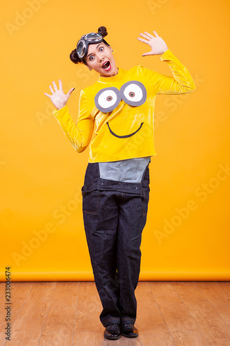 Beautiful young woman wearing funny minion pullover. Funny moment