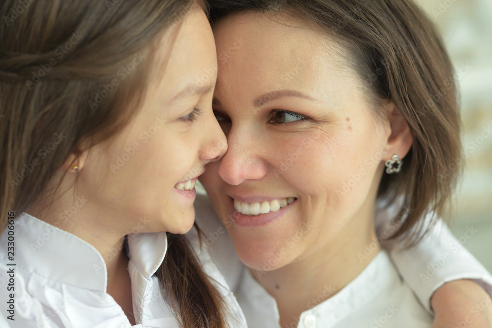 Portrait of beautiful woman and girl at home Portrait of beautiful woman and girl at home