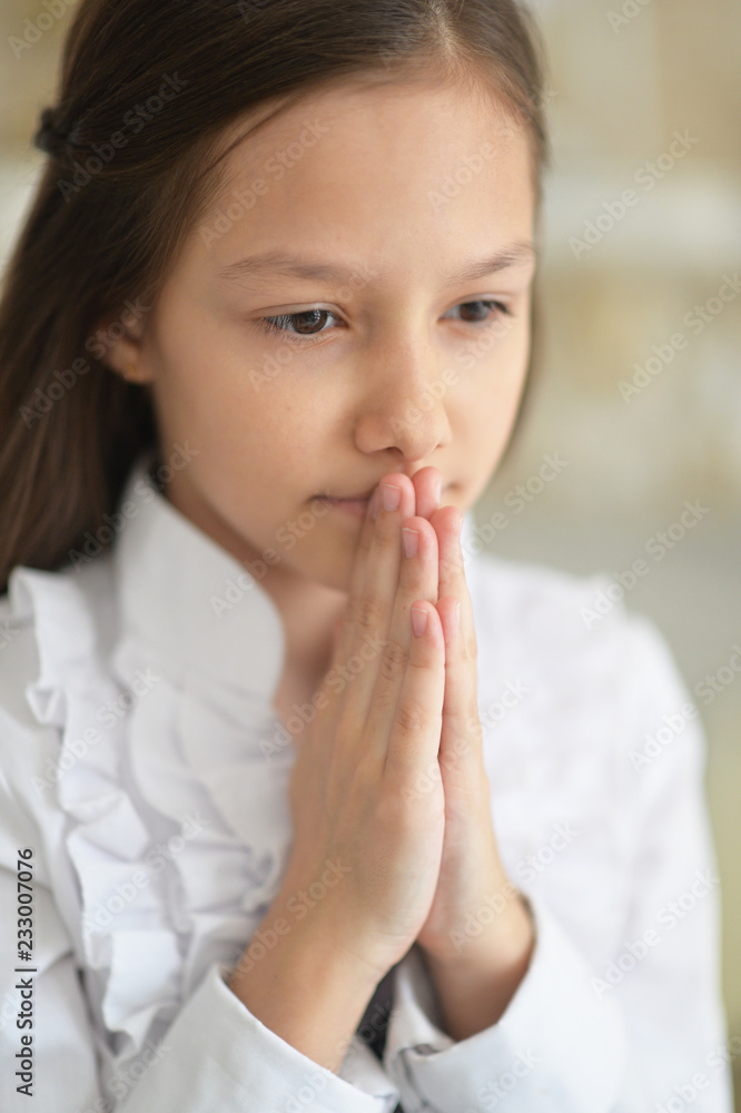 Portrait of a cute girl praying at home Portrait of a cute girl praying at home