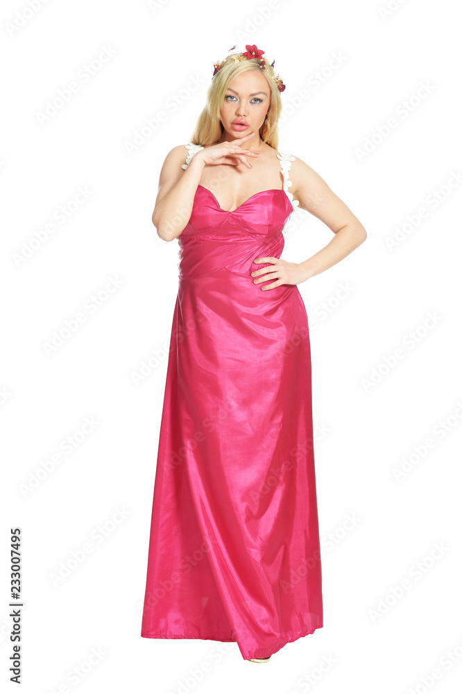 Beautiful woman in pink dress posing on white background