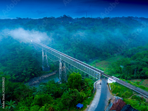 Scenic Aerial View of Cirahong Bridge, A Double Deck Structure of Metal Railway Bridge and Car Bridge Underneath Made by Dutch Colonial, Manonjaya Tasikmalaya, West Java Indonesia, Asia photo