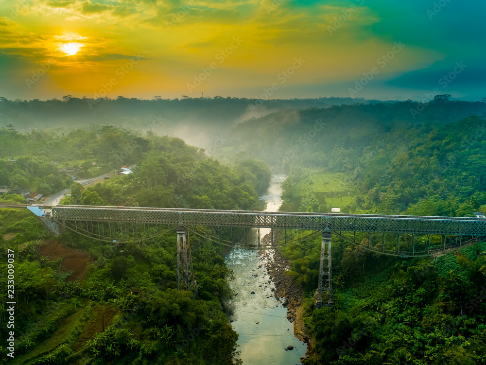 Obraz premium Scenic Aerial View of Cirahong Bridge, A Double Deck Structure of Metal Railway Bridge and Car Bridge Underneath Made by Dutch Colonial, Manonjaya Tasikmalaya, West Java Indonesia, Asia