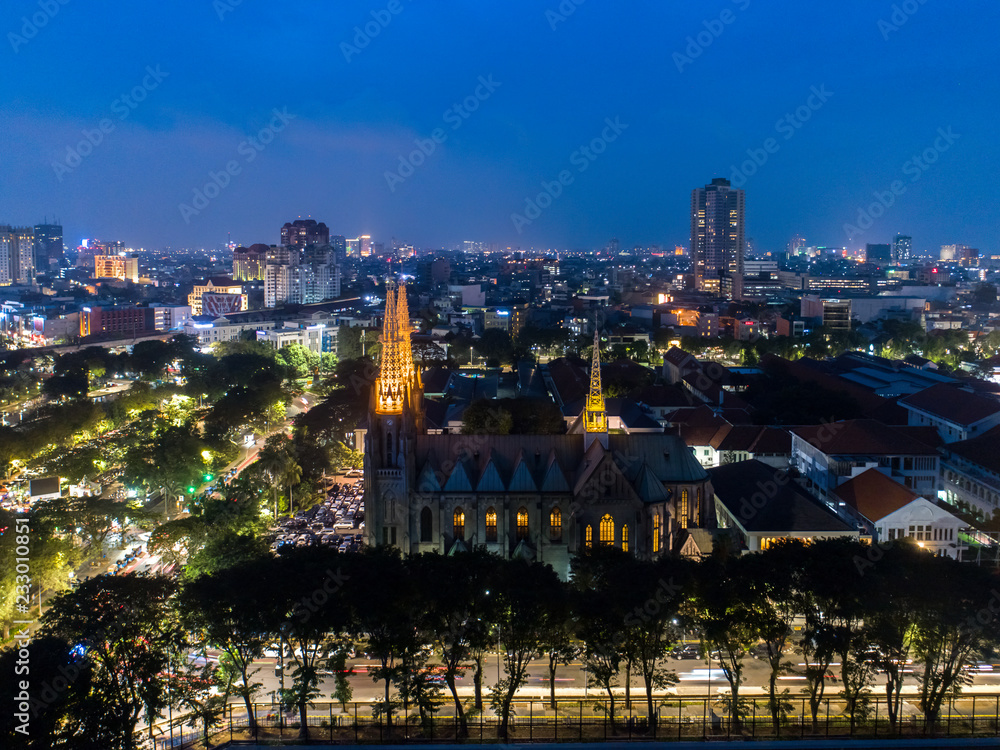 Naklejka premium Aerial View of Jakarta Cityscape at Blue Hour in the Evening, with Blue Sky and City Lights