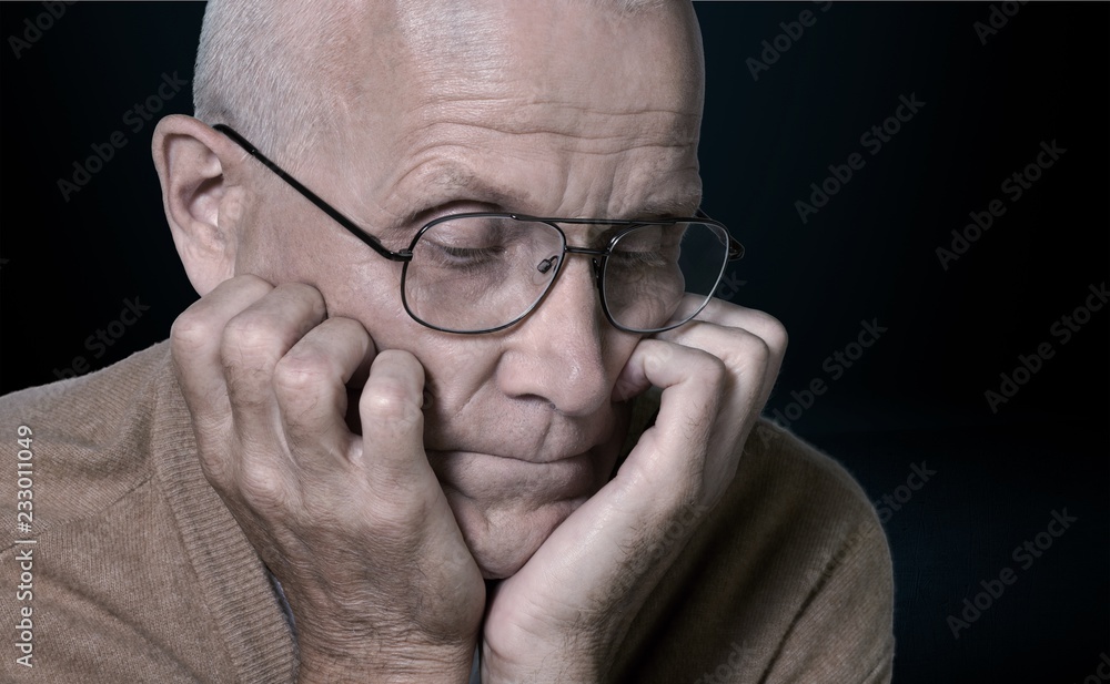 Thoughtful senior man with glasses at home Thoughtful senior man with glasses at home