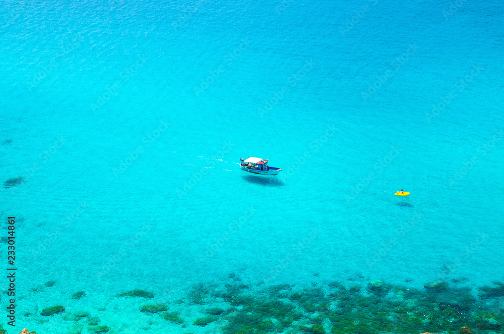 Fototapeta premium Fishing yacht and rubber boat in Capo Vaticano lagoon, Calabria, Italy