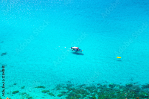 Fototapeta Naklejka Na Ścianę i Meble -  Fishing yacht and rubber boat in Capo Vaticano lagoon, Calabria, Italy