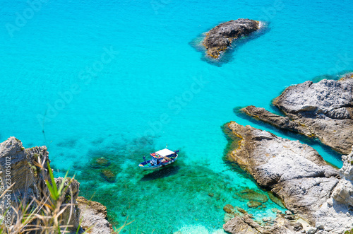 Fishing yacht boat in tropical lagoon Capo Vaticano, Calabria, Italy