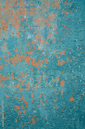 Vertical background old cracked paint on fence, primer orange, peeling paint green