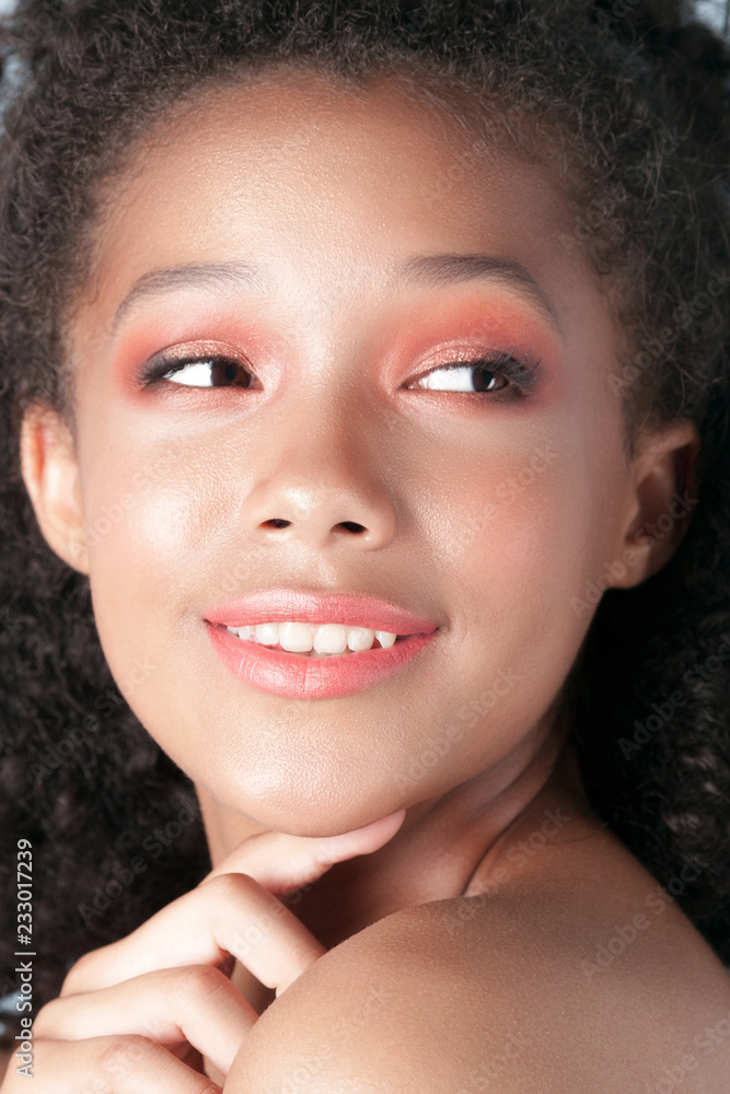 Young beautiful black girl with clean perfect skin close-up