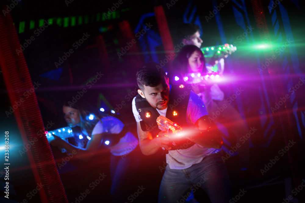 Fototapeta premium Guy in colored beams during laser tag game