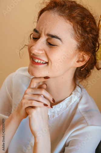 portrait of a beautiful young woman with red hair, smiling with happiness