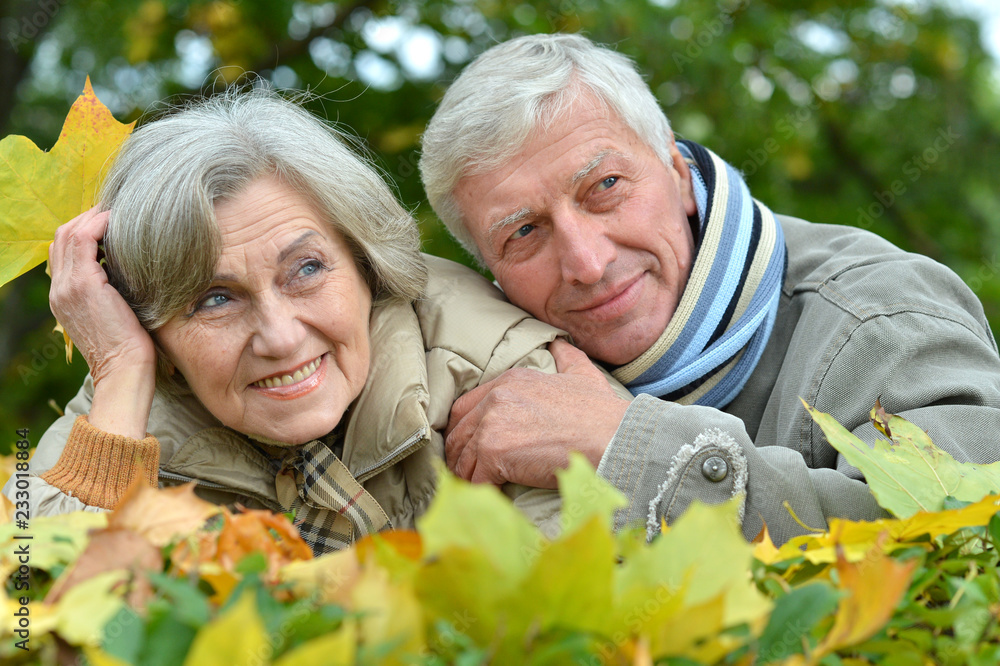 Portrait of happy senior couple lying in park Portrait of happy senior couple lying in park