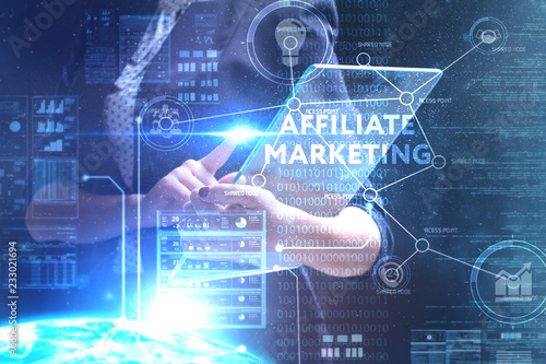 The concept of business, technology, the Internet and the network. A young entrepreneur working on a virtual screen of the future and sees the inscription: Affiliate marketing