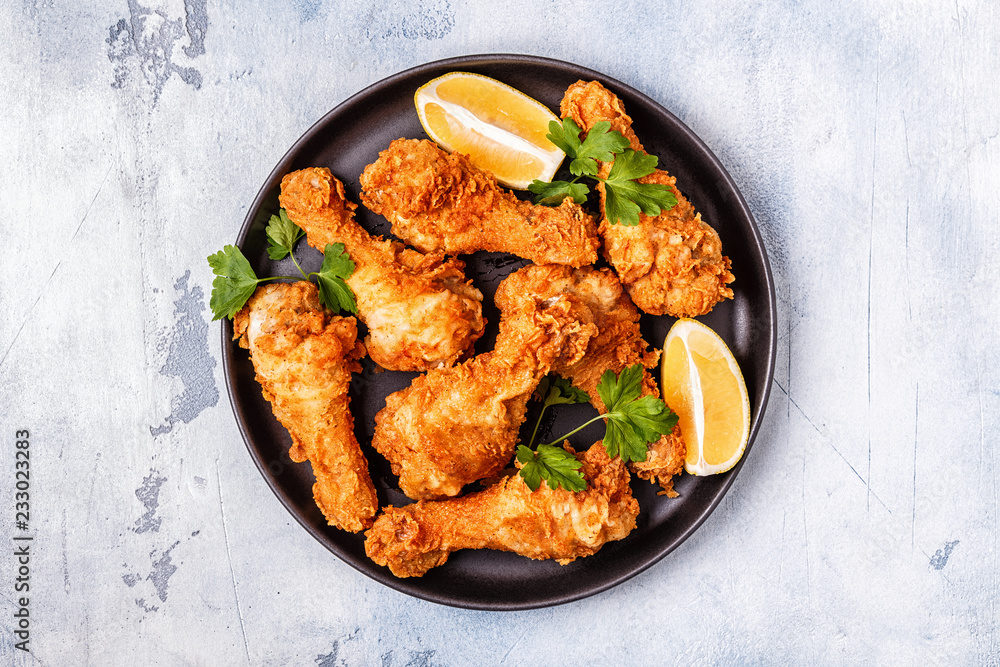 Fried chicken legs with lemon and parsley. Fried chicken legs with lemon and parsley.