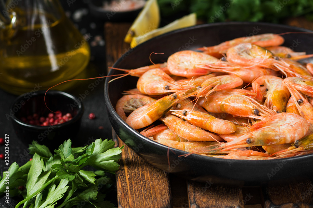 Shrimp in a black plate on a black background