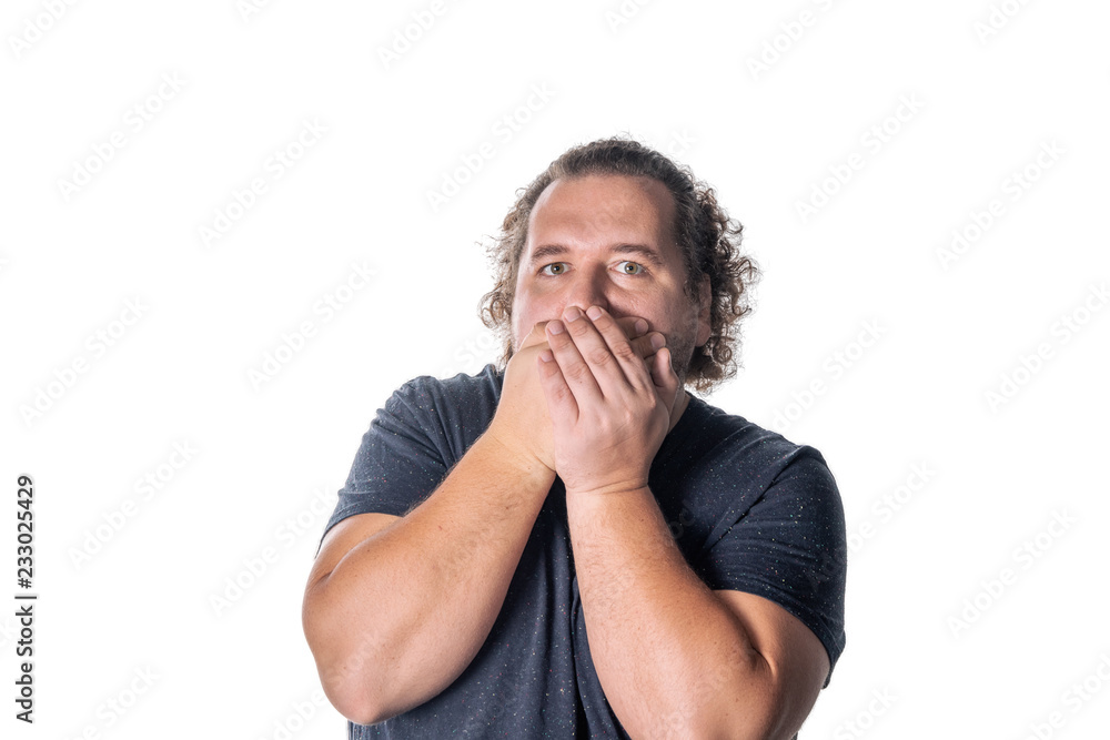 Portrait of amazed man covering his mouth over white background. Say no evil concept Portrait of amazed man covering his mouth over white background. Say no evil concept