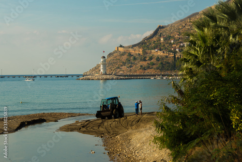 View of landscape and lghthouse of Alanya port with Turkish flag, Alanya, Turkey photo