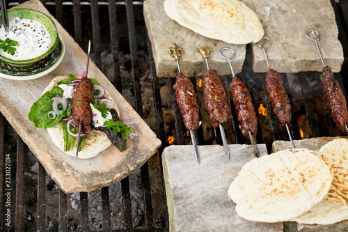 Shish kebabs with flatbread served on marble board photo