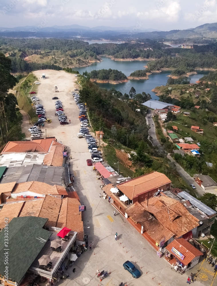 Touristic Villa of the Stone of Guatape or Peñol in Antioquia, Colombia with sight of the zone of tourism and some lakes of the reservoir dam.