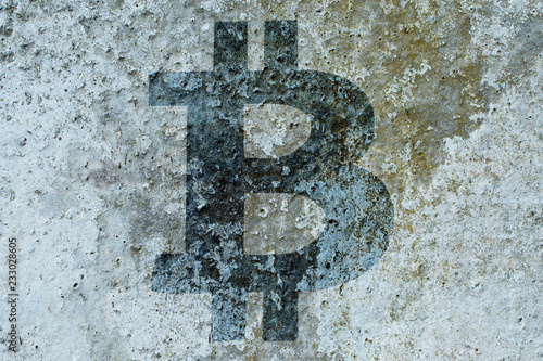 Bitcoin sign on a concrete wall, the concept of the indestructibility of cryptocurrency photo