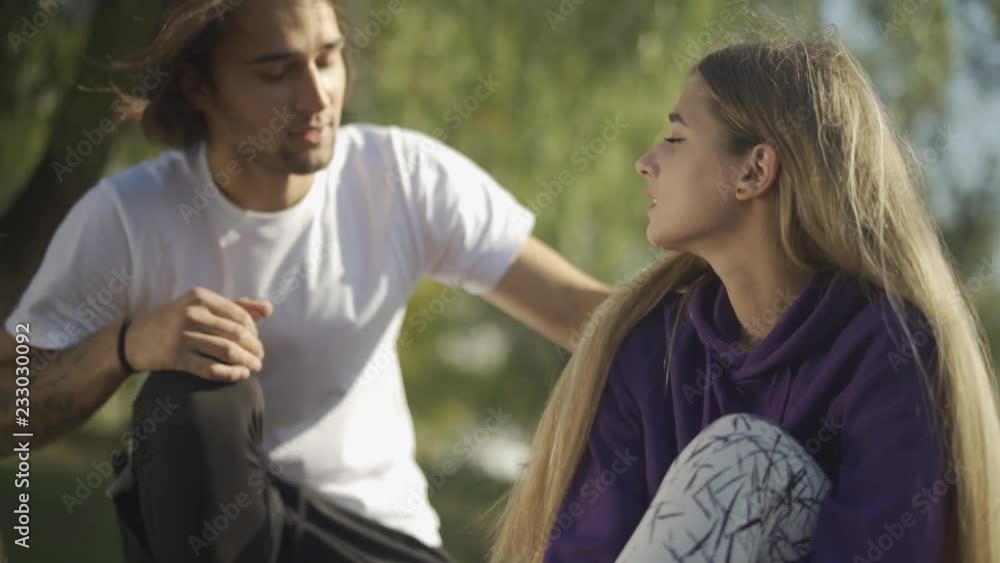 The guy runs up to the girl who hurt his leg The guy runs up to the girl who hurt his leg