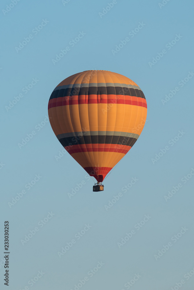 Obraz premium Orange hot air balloons against blue sky