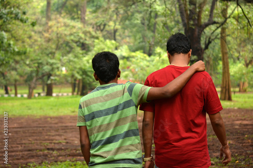 Two Friends walking around the park during evening time in Cubbon park of Bengaluru,India
