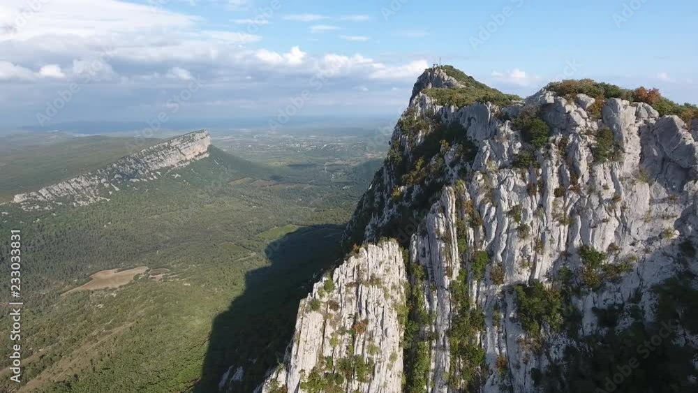Beautiful cliff of the mountain pic saint loup with valley in background. Aerial drone shot sunny day Beautiful cliff of the mountain pic saint loup with valley in background. Aerial drone shot sunny day