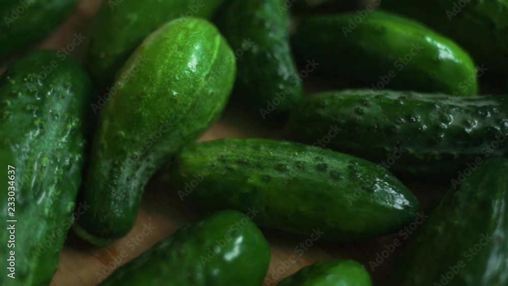 Fresh cucumbers on wooden background. Healthy vegetables. Delicious fresh cucumbers rotate on wooden background. Fresh cucumbers on wooden background. Healthy vegetables. Delicious fresh cucumbers rotate on wooden background.