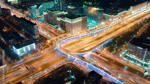 Beautiful motion timelapse of the big road junction on the night, view from above. Aerial shot of busy crossroad in Moscow center with a lot of traffic and glittering city lights.