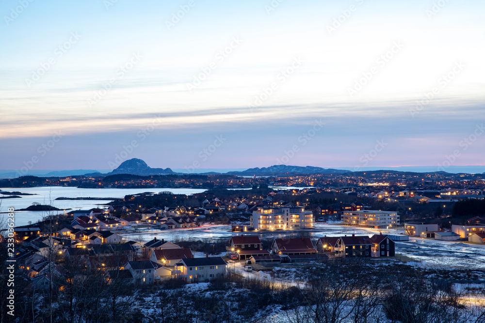 City at night - View from a hill outside the city towards the town and the mountain Torghatten; County of Nordland