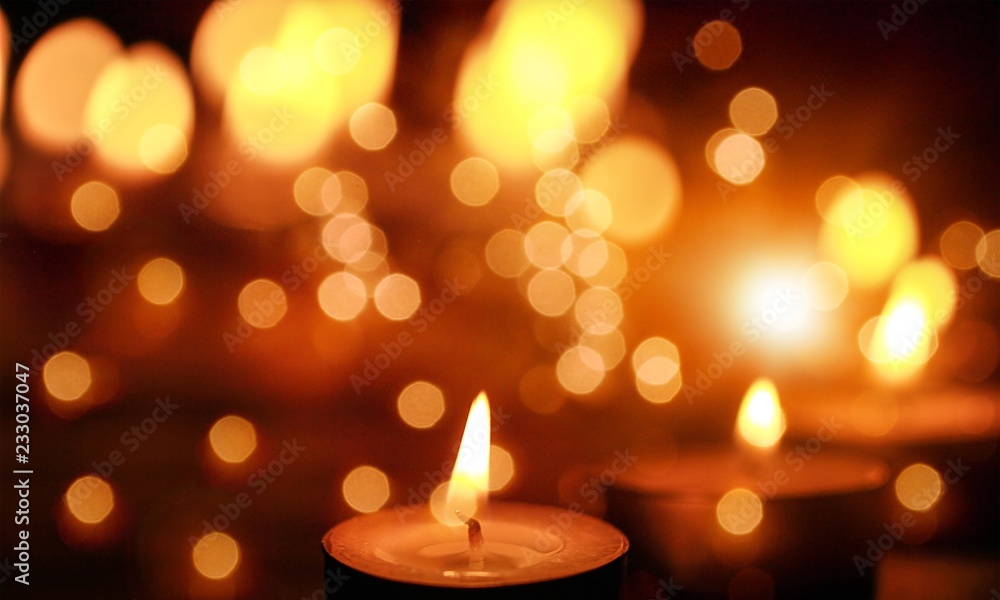 Close up view of the candles cutting through the darkness. Close up view of the candles cutting through the darkness.