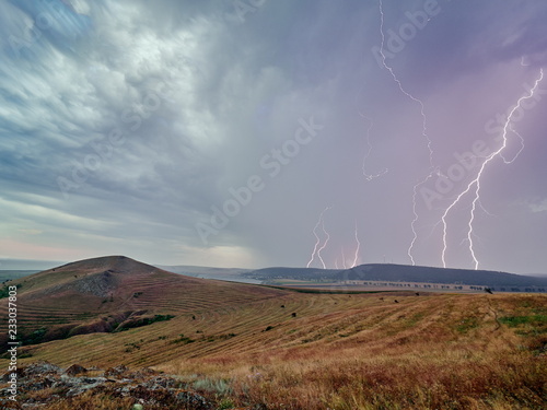 Thunderstorm with lightnings over the fields