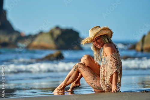 young woman relaxing on the beach in summer day photo