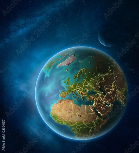 Planet Earth with highlighted Serbia in space with Moon and Milky Way. Visible city lights and country borders.