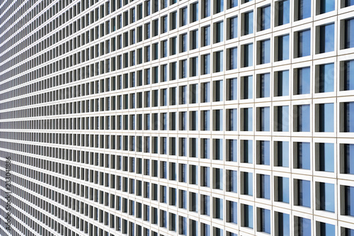The outgoing perspective of the windows of the facade of a modern building. Glass grey square Windows of modern city business building skyscraper. Windows of a building, texture.