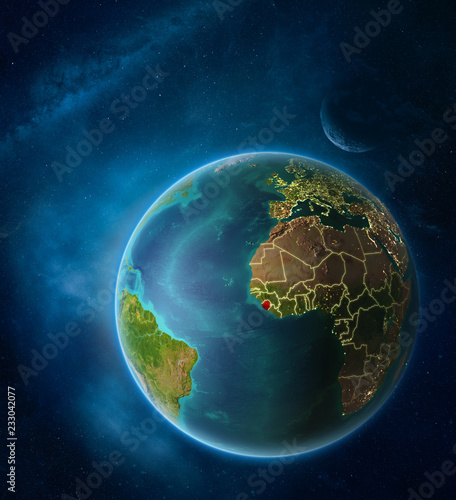 Planet Earth with highlighted Sierra Leone in space with Moon and Milky Way. Visible city lights and country borders.