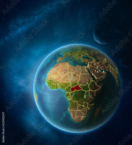 Planet Earth with highlighted Central Africa in space with Moon and Milky Way. Visible city lights and country borders.