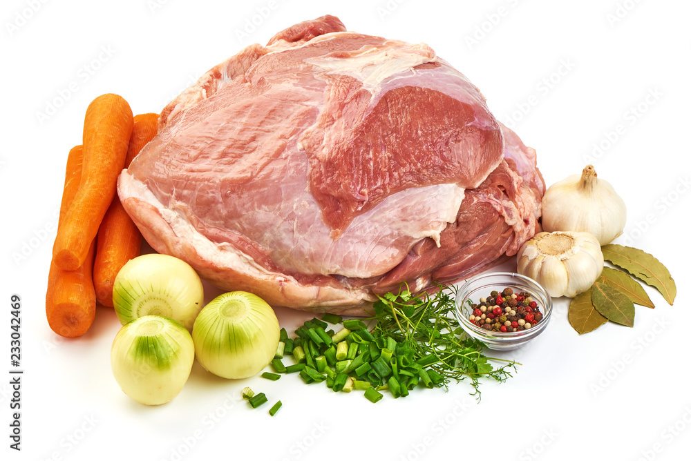 Uncooked ham or gammon with vegetables on a cutting board, isolated on a white background. Close-up. Uncooked ham or gammon with vegetables on a cutting board, isolated on a white background. Close-up.