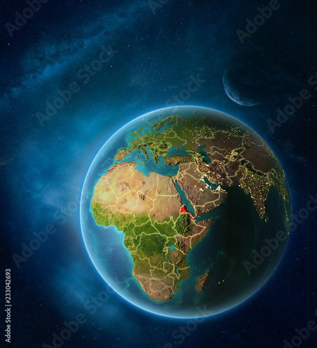 Planet Earth with highlighted Eritrea in space with Moon and Milky Way. Visible city lights and country borders.