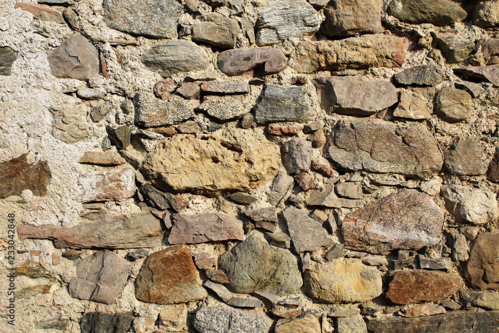 Ancient dry stone wall bricks texture close up view