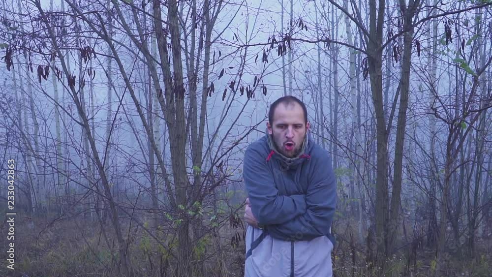 sick man shivers due to cold autumn or fall weather in the outdoor hd. sick man shivers due to cold autumn or fall weather in the outdoor hd.