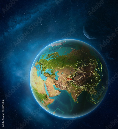 Planet Earth with highlighted Tajikistan in space with Moon and Milky Way. Visible city lights and country borders.