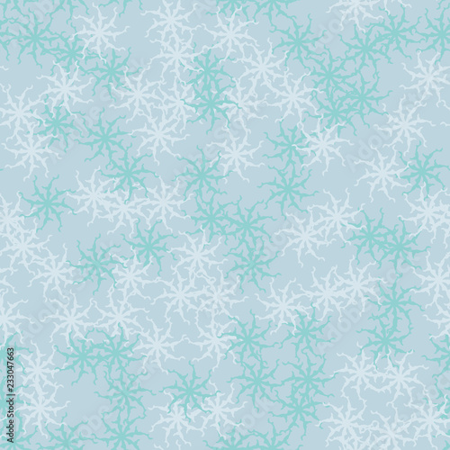 Winter seamless pattern with chaotic snowflakes in different shades of blue color