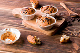 Delicious homemade muffins on wood.
