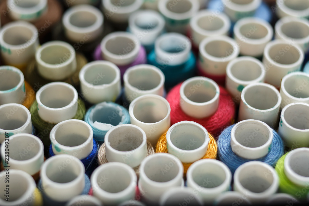top view on closeup set of skeins of multi-colored sewing thread.Tailor industry top view on closeup set of skeins of multi-colored sewing thread.Tailor industry