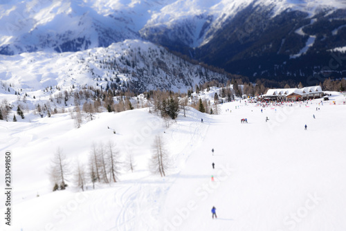ski slope with skiers in the Alps © Stefania